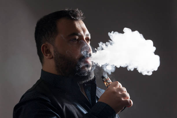 electronic cigarette smoker beard man - detrimental imagens e fotografias de stock