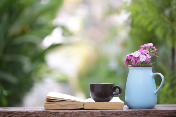 istock Black cup and pink flower in blue pot with 929644898