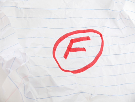 a red grade f on crumpled paper.