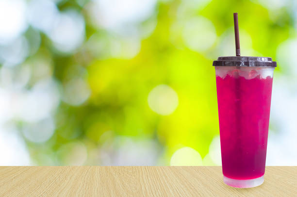 Glasses of sweet water pink soda with ice cubes