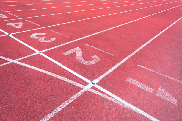 istock Numbers starting point on red running track,running track and green grass 929661616