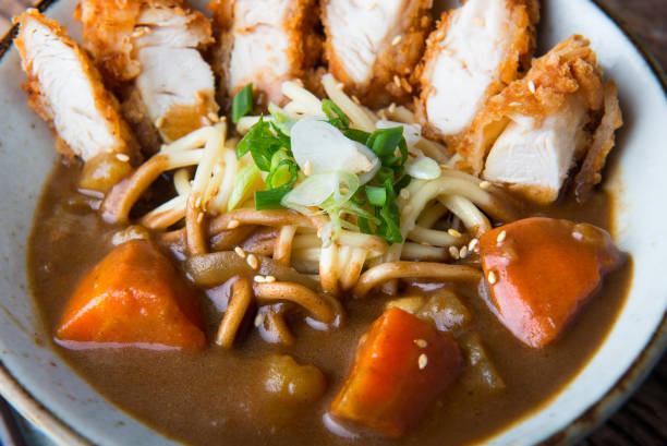 Japanese curry with udon noodle and crispy chicken. Japanese curry with udon noodle and crispy chicken tenderloid in bowl cup style ready to serve. sticky sesame chicken sauces stock pictures, royalty-free photos & images