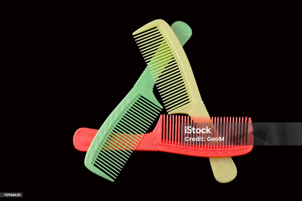 COMBination. Triangle COMBination. Triangle of three coloured plastic combs Animal Hair Stock Photo