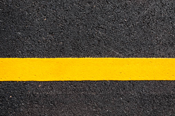 istock Yellow line on new asphalt detail 929666480