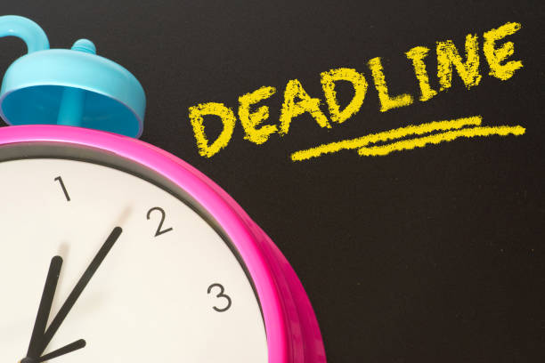 istock An alarm clock and chalkboard with the word Deadline 929670738