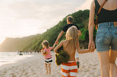 Family  walking on the beach in Bali
