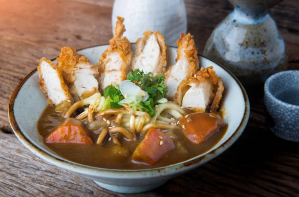 Japanese curry with udon noodle and crispy chicken. Japanese curry with udon noodle and crispy chicken tenderloid in bowl cup style ready to serve. sticky sesame chicken sauces stock pictures, royalty-free photos & images