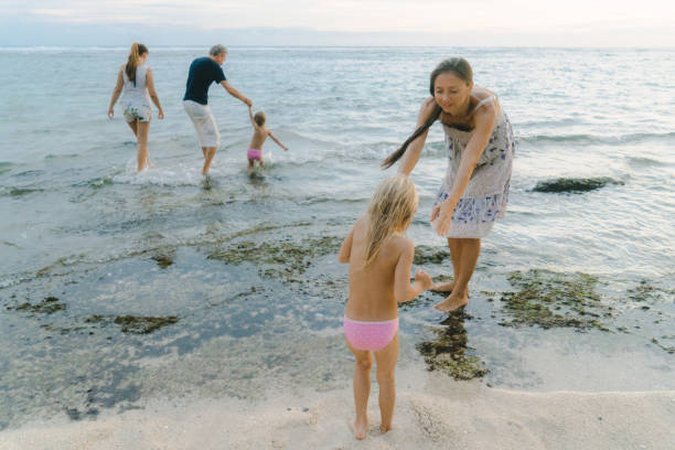 istock Family  with three children playing in the sea 929672202
