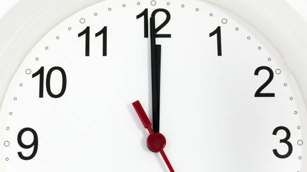 istock Closeup clock ticking showing twelve hours 929673132