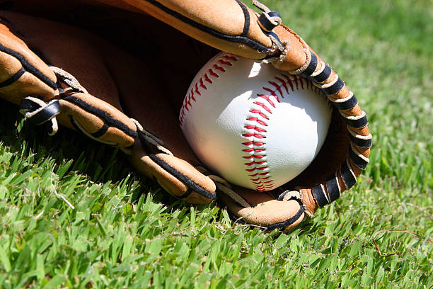 istock Lets Play Ball - Baseball and glove on grassy field. 92968530