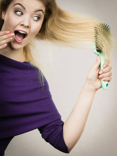 istock Woman brushing her long hair with brush 929697088