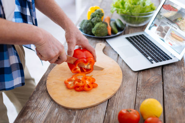 istock Appealing male hands shredding bell pepper 929697394