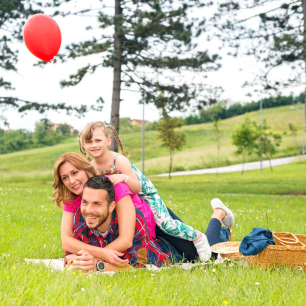 istock Cheerful loving family making human pyramid in park 929698158