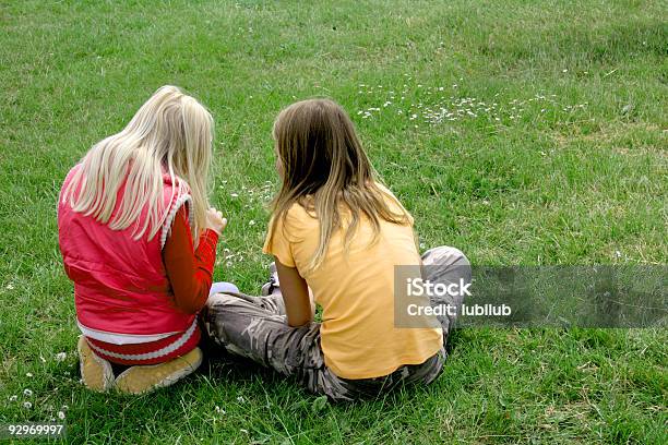 Best Friends Two Girls Picking Daisies From The Lawn Stock Photo - Download Image Now