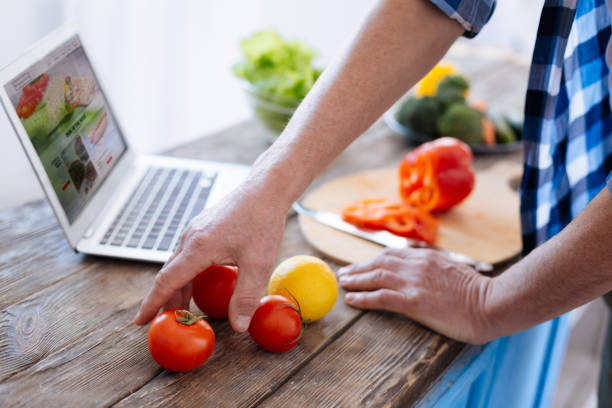 istock Tender male hand grabbing tomato 929700460