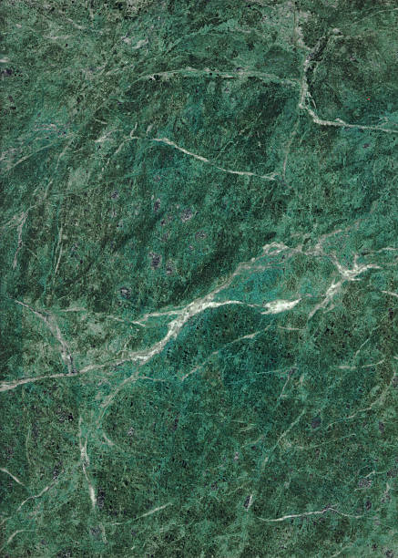 Green marble-texture background with white accents stock photo