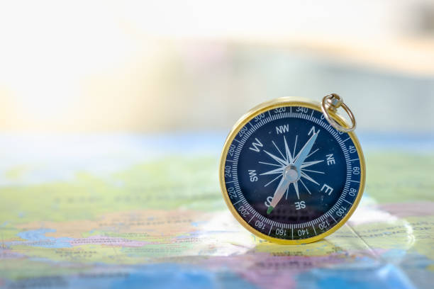 istock Travel Concept. Close up of compass on world map. 929716504
