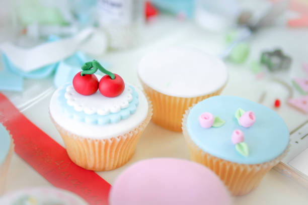 istock Rose and cherry fondant cupcakes. 929720168