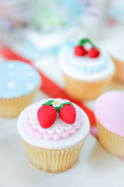 istock Rose and strawberry fondant cupcakes. 929720174