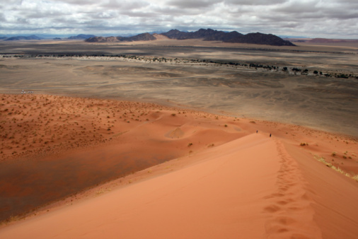 Deadvlei is a white clay pan located near the more famous salt pan of Sossusvlei, inside the Namib-Naukluft Park in Namibia. Dead Vlei has been claimed to be surrounded by the highest sand dunes in the world, the highest reaching 300–400 meters (350m on average, named \