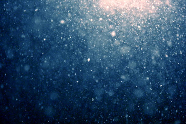 istock falling snow at night with street light 929728688