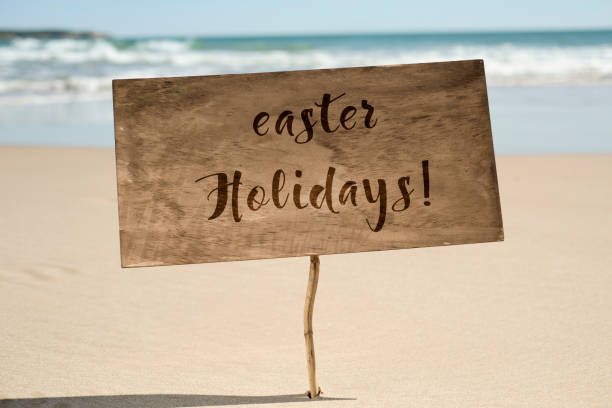 istock text easter holidays in a signboard on the beach 929734368