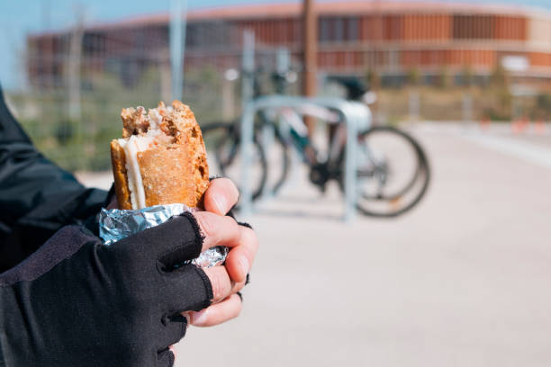 istock young cyclist man eating a sandwich 929734546