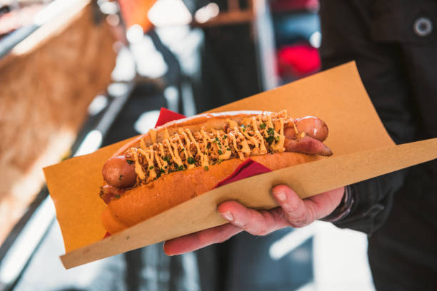 istock Hot Dog with wrapping paper in hands 929739172