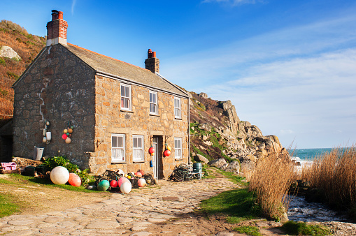 An exterior view of a fisherman's cottage next to the sea, Penberth, Cornwall.