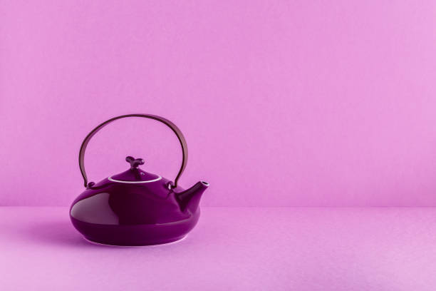 istock Purple teapot and cups on a lilac background 929742978