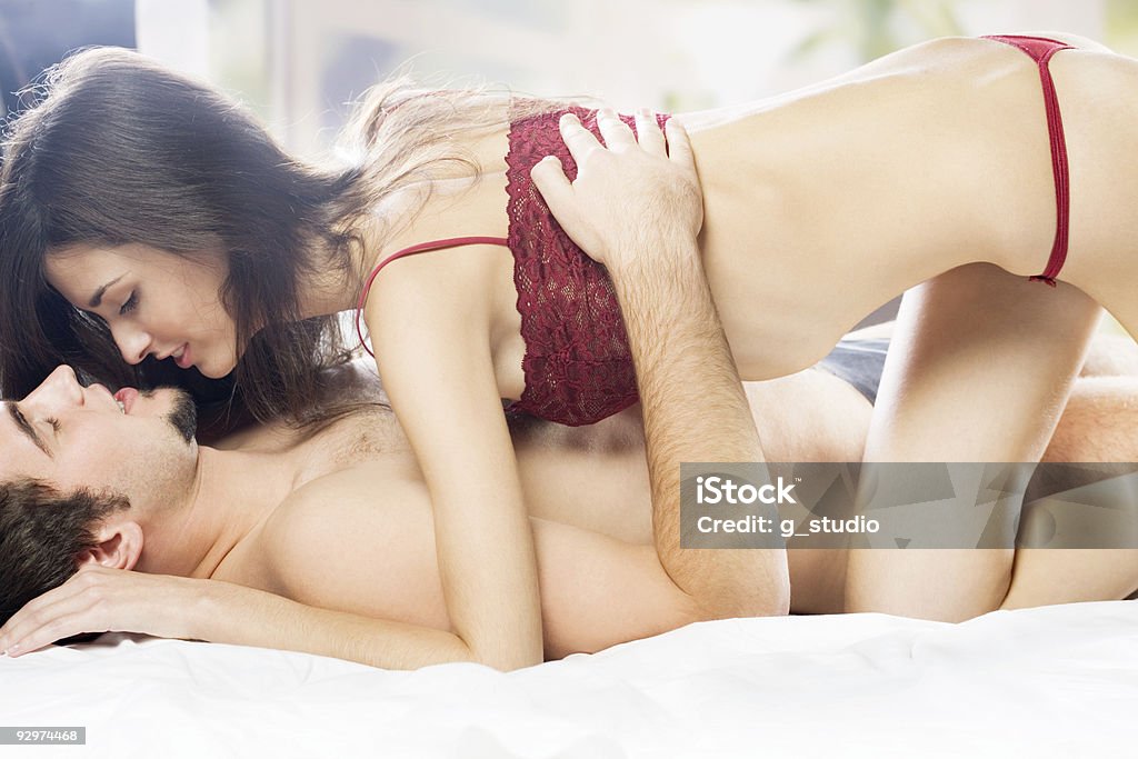 Couple hugging on the bed Couple hugging on the bed in bedroom, in passion Couple - Relationship Stock Photo
