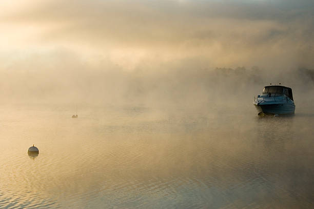 Boat in the mist stock photo