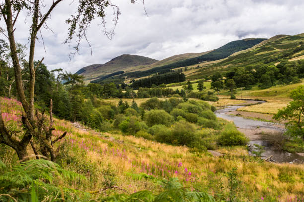Dark clouds hovering above the mountain peaks and lakes on Scottish Highlands.