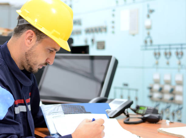 istock Young engineer working in electrical room in power substation 929754922