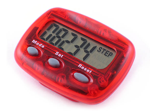 Red pedometer reader on a white table Digital Pedometer isolated on a white background. Displaying steps. pedometer photos stock pictures, royalty-free photos & images
