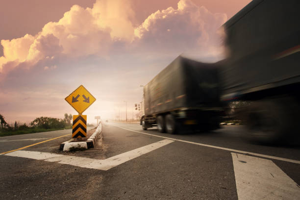 istock Blurry truck with fork in the road sign. 929760174