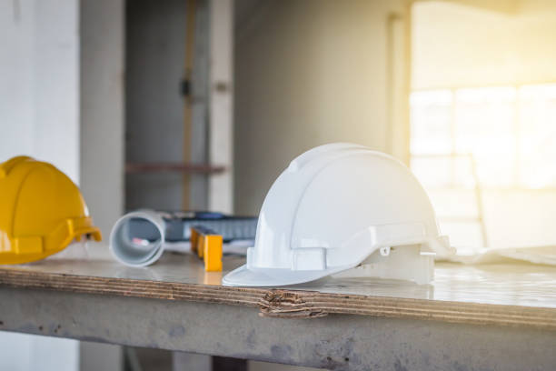 istock The safety helmet and the blueprint on table at construction site 929760738