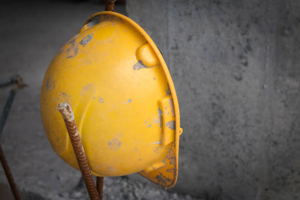 istock The old yellow safety helmet at construction site in dark tone 929760912
