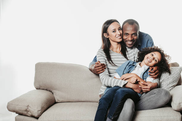 istock Enjoyed daddy hugging happy child and wife on sofa 929761806