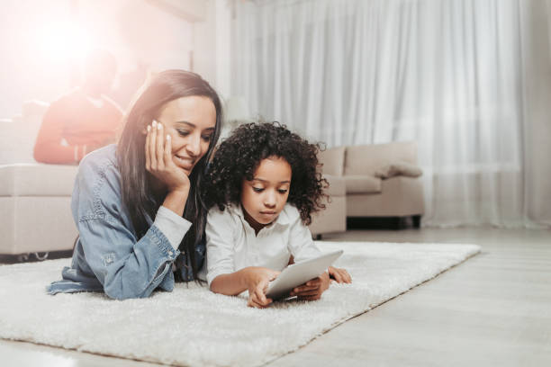 istock Glad mom paying attention to kid while lying together 929764218