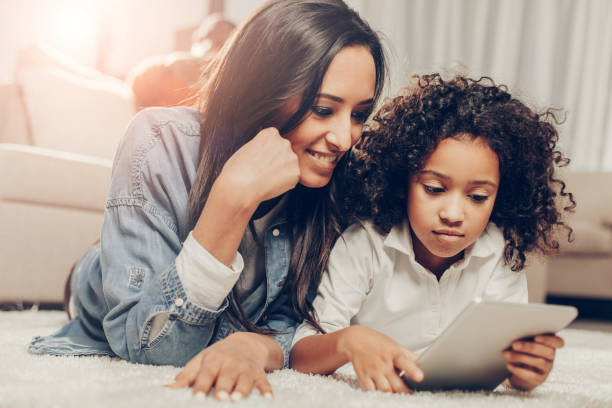 istock Mother and child relaxing and staring at tablet 929764254