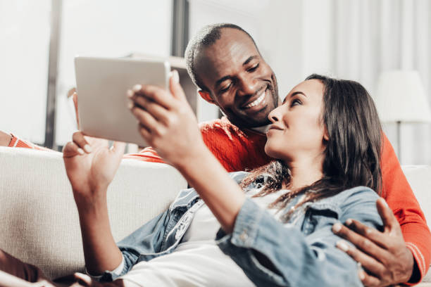 istock Two happy enamored people passing the time with device 929765174