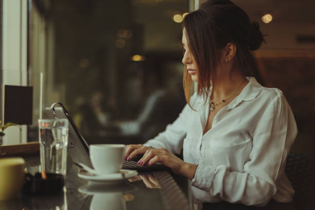 istock Businesswoman sitting in the cafe, drinking coffee and using digital tablet 929776234