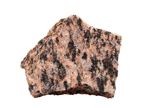 Natural specimen of fine-grained granite, the best-known intrusive igneous rock composed mainly of quartz and feldspar with minor amounts of mica, amphiboles, and other minerals on white background