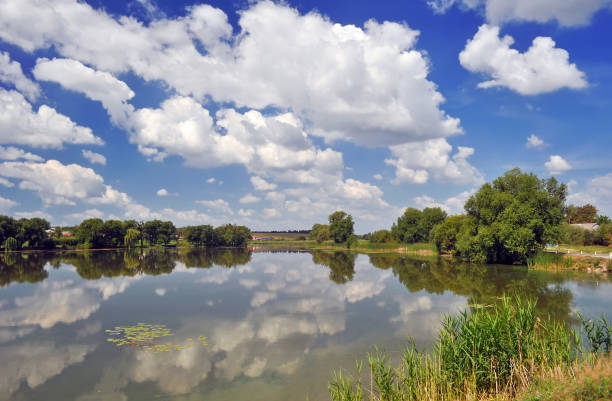 istock Summer lake with clouds in the sky 929780586