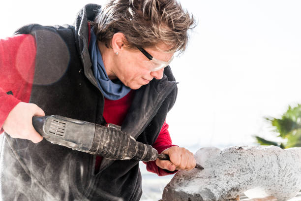 istock Mature Woman Making Sculpture From Repen Stone 929781006