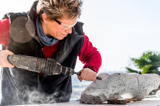 istock Mature Woman Making Sculpture From Repen Stone 929781012