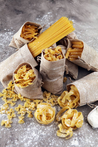 istock Various mix of pasta on grey rustic background. Diet and food concept. 929785750
