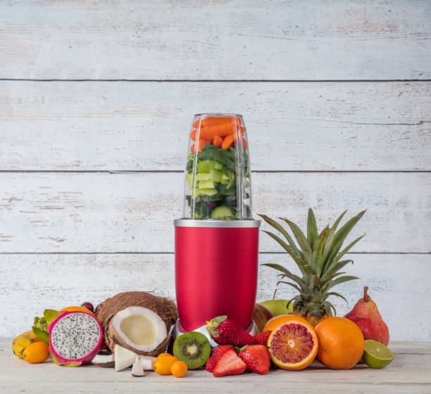 istock Smoothie maker mixer with pieces of fruit ingredients 929787070