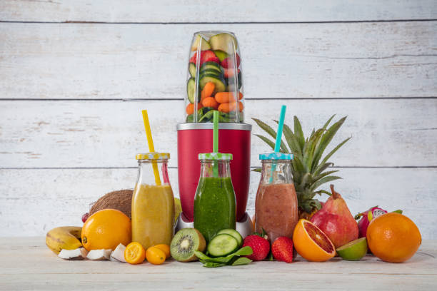 istock Smoothie maker mixer with pieces of fruit ingredients 929787216